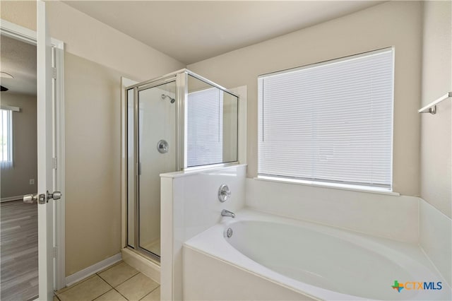 bathroom featuring tile patterned flooring and independent shower and bath