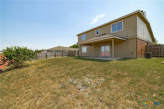 rear view of house with a yard and a patio