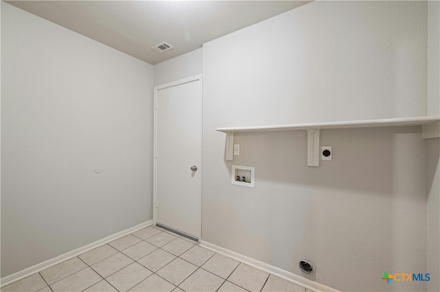 laundry room featuring hookup for a washing machine, light tile patterned floors, and hookup for an electric dryer