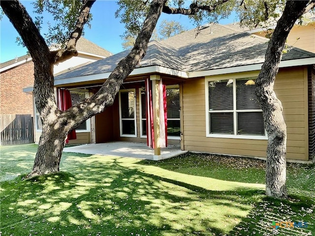 view of front of home with a front lawn and a patio area