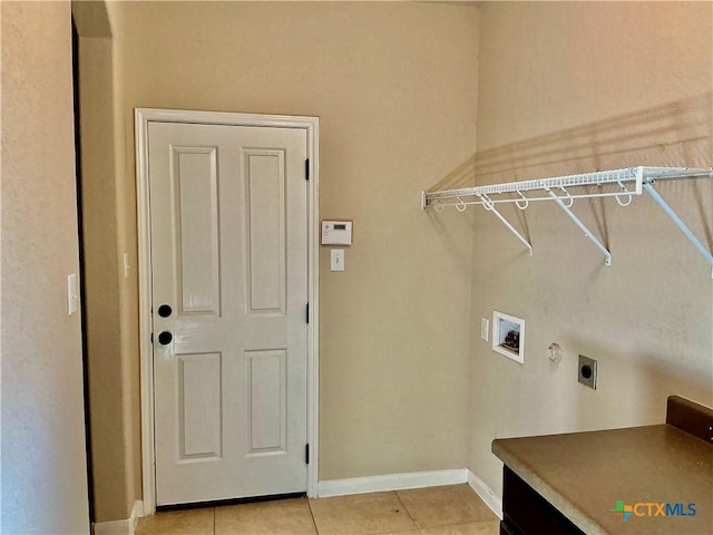 clothes washing area featuring washer hookup, light tile patterned floors, and electric dryer hookup