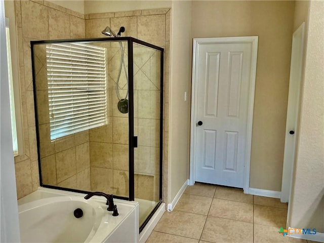 bathroom featuring tile patterned flooring and shower with separate bathtub