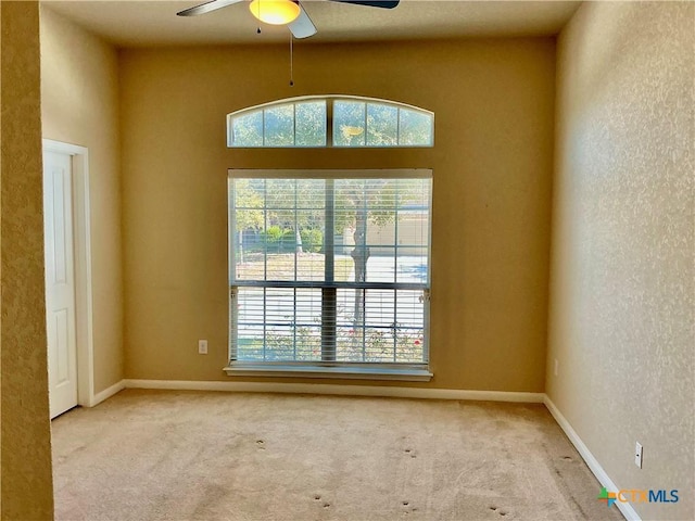 unfurnished room featuring light colored carpet and ceiling fan