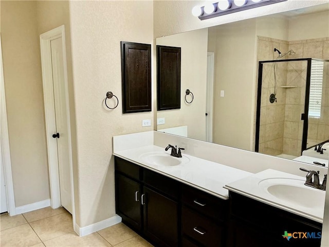 bathroom with tile patterned flooring, vanity, and a shower with door