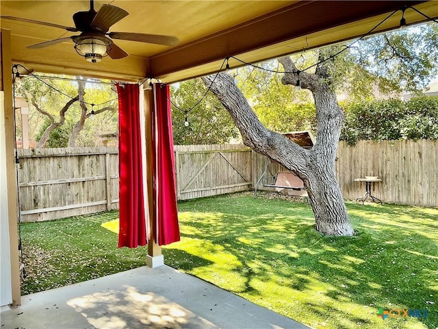 view of yard with a patio and ceiling fan