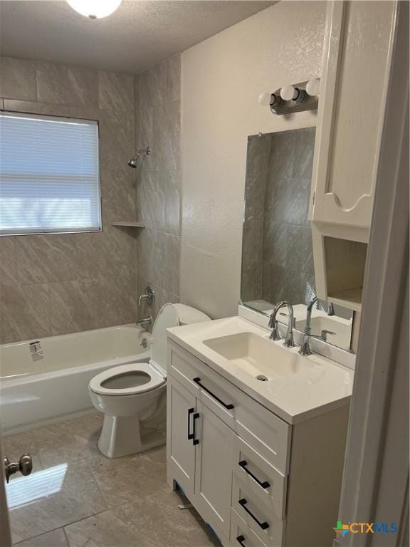 full bath featuring toilet, vanity, a textured ceiling, and shower / bathing tub combination