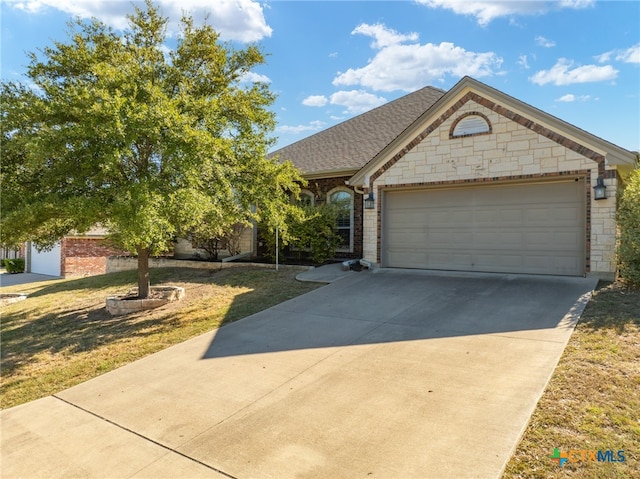 view of front of house featuring a garage and a front yard