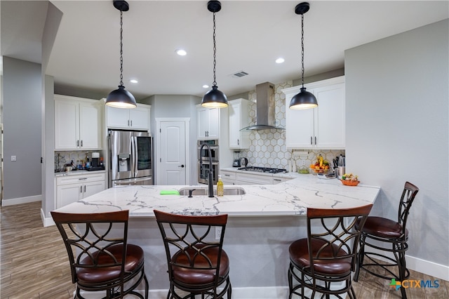200 Wood Cv, Georgetown, TX 78633 - kitchen featuring wall chimney range hood, stainless steel appliances, baseboards, decorative backsplash, and recessed lighting