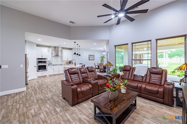 200 Wood Cv, Georgetown, TX 78633 - living room featuring ceiling fan, light wood finished floors, recessed lighting, a high ceiling, and baseboards
