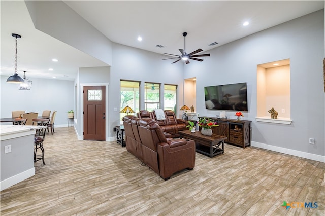 200 Wood Cv, Georgetown, TX 78633 - living room featuring light wood finished floors, ceiling fan, baseboards, recessed lighting, and a high ceiling