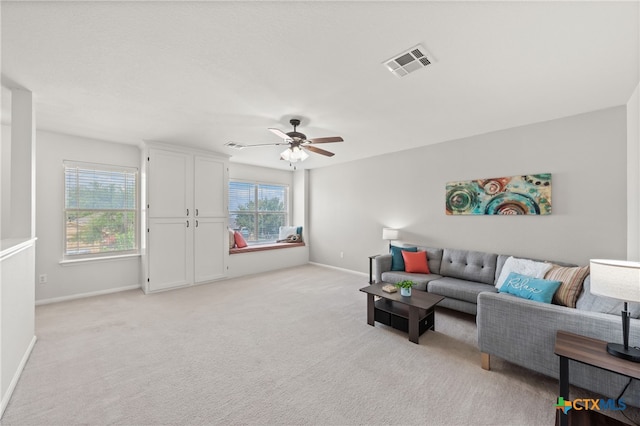 carpeted living room with ceiling fan