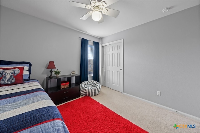 bedroom with ceiling fan, a closet, and carpet