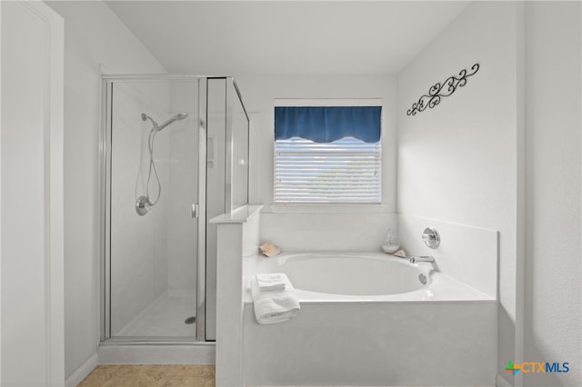 bathroom with tile patterned flooring and independent shower and bath