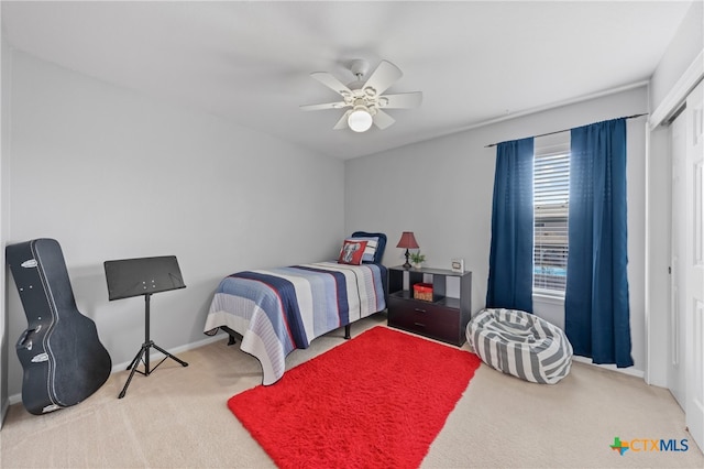 carpeted bedroom with a closet and ceiling fan