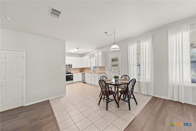 dining room featuring light hardwood / wood-style floors and sink