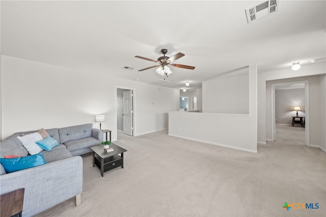 carpeted living room with ceiling fan