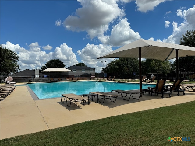 view of swimming pool with a patio and a yard