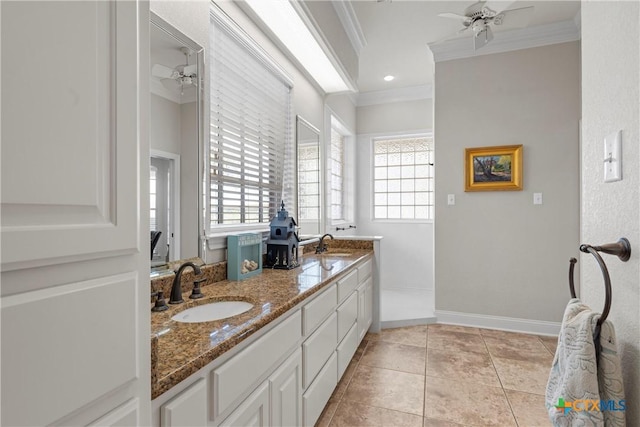 full bathroom featuring ceiling fan, a healthy amount of sunlight, ornamental molding, and a sink