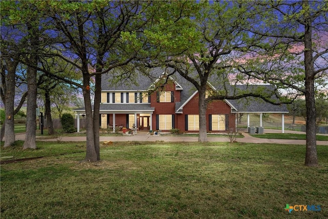 view of front of property with central air condition unit, a front lawn, and covered porch