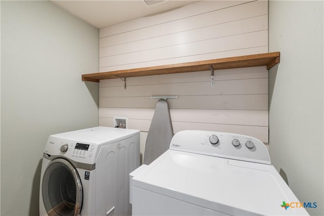 clothes washing area featuring independent washer and dryer