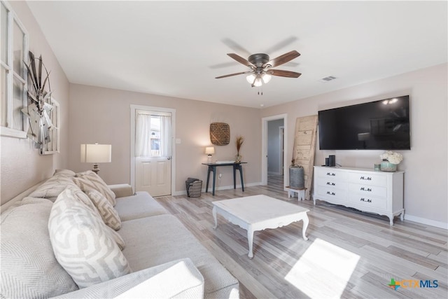 living room with ceiling fan and light hardwood / wood-style flooring