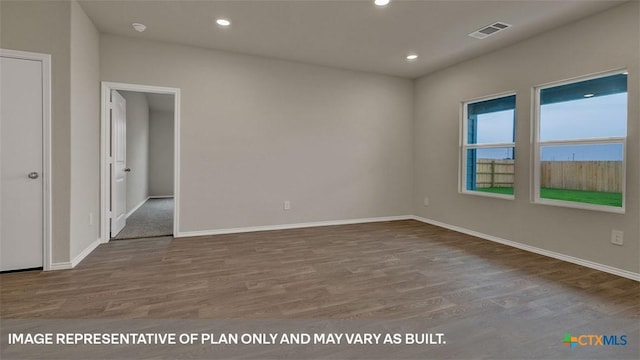 empty room with hardwood / wood-style flooring