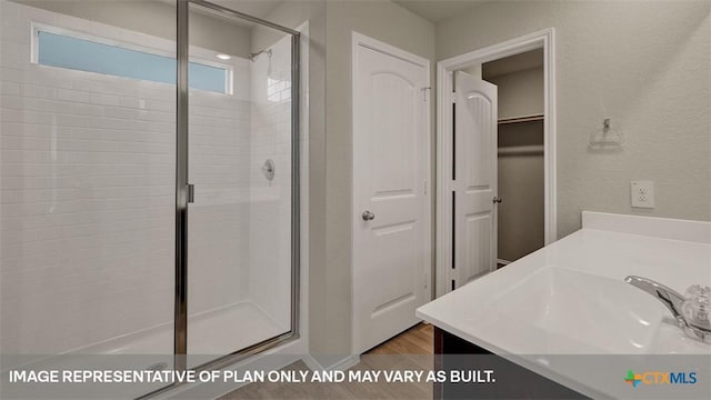 bathroom with vanity, hardwood / wood-style floors, and walk in shower