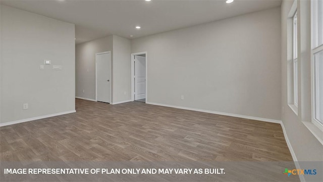 unfurnished room with wood-type flooring