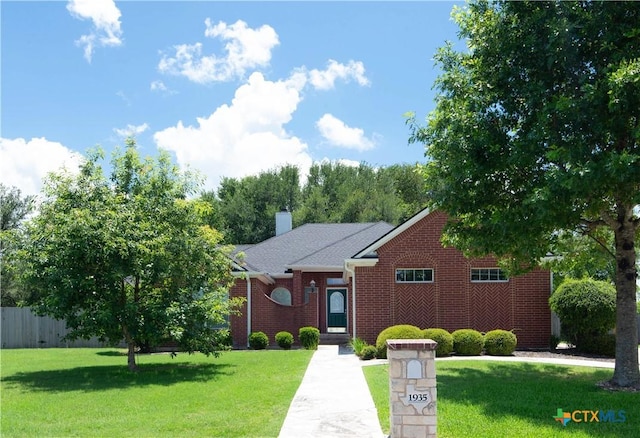 1935 Grandview Dr, Salado, TX 76571 - view of front of home featuring a front lawn, a chimney, and brick siding