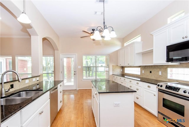 1935 Grandview Dr, Salado, TX 76571 - kitchen featuring stainless steel appliances, a kitchen island, white cabinetry, and tasteful backsplash