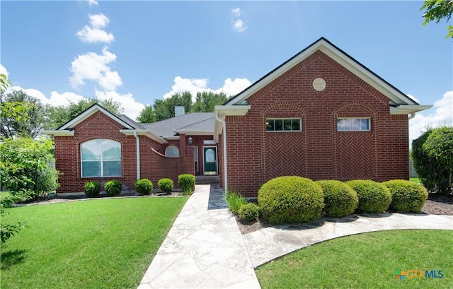 1935 Grandview Dr, Salado, TX 76571 - ranch-style house with a front yard, brick siding, and a chimney