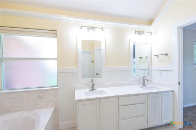 1935 Grandview Dr, Salado, TX 76571 - full bathroom featuring double vanity, a bath, wainscoting, and crown molding