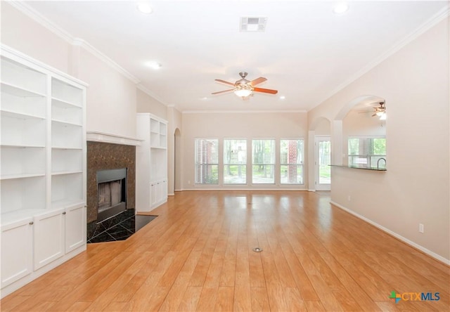 1935 Grandview Dr, Salado, TX 76571 - unfurnished living room with a ceiling fan, a fireplace, light wood-type flooring, arched walkways, and recessed lighting