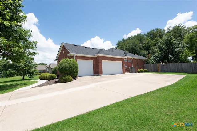 1935 Grandview Dr, Salado, TX 76571 - view of side of home with a garage, driveway, and brick siding