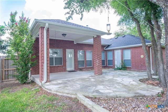1935 Grandview Dr, Salado, TX 76571 - back of property featuring brick siding, roof with shingles, and a patio