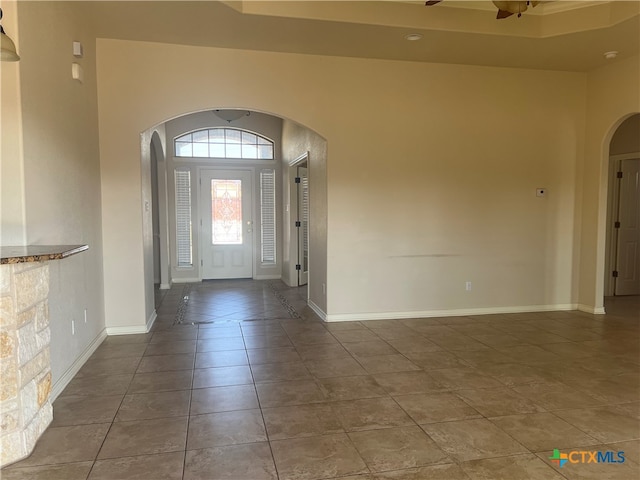 entryway featuring tile patterned floors and ceiling fan