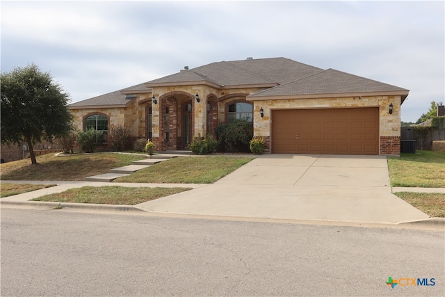 ranch-style house with a garage and a front lawn