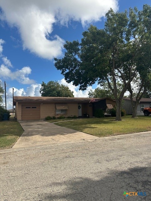 ranch-style house with a front lawn and a garage