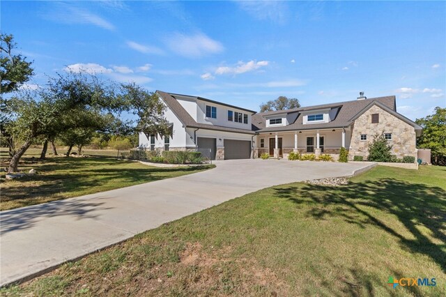 view of front of property with a garage and a front lawn