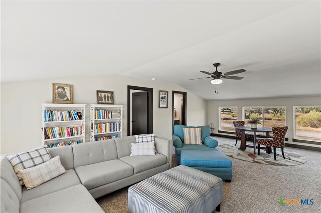 carpeted living room featuring vaulted ceiling and ceiling fan