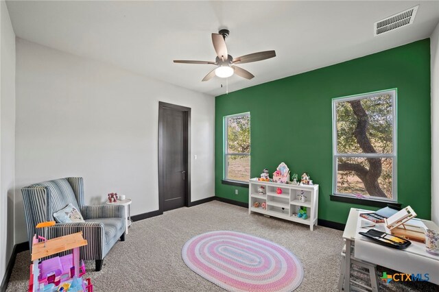 playroom featuring carpet and ceiling fan