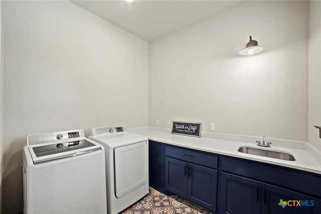 laundry area featuring cabinets, sink, and washing machine and clothes dryer