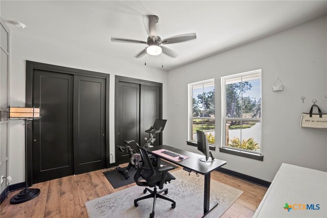 office space featuring ceiling fan and light hardwood / wood-style floors