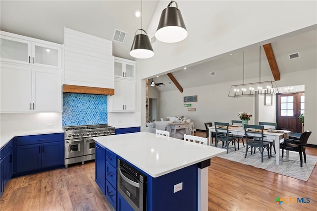 kitchen with blue cabinetry, pendant lighting, stainless steel appliances, and white cabinets