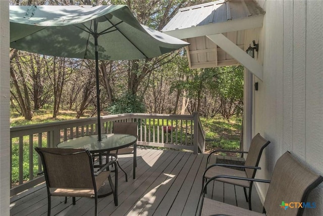 wooden deck with outdoor dining area