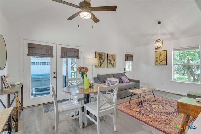 living room with high vaulted ceiling, wood finished floors, french doors, and ceiling fan