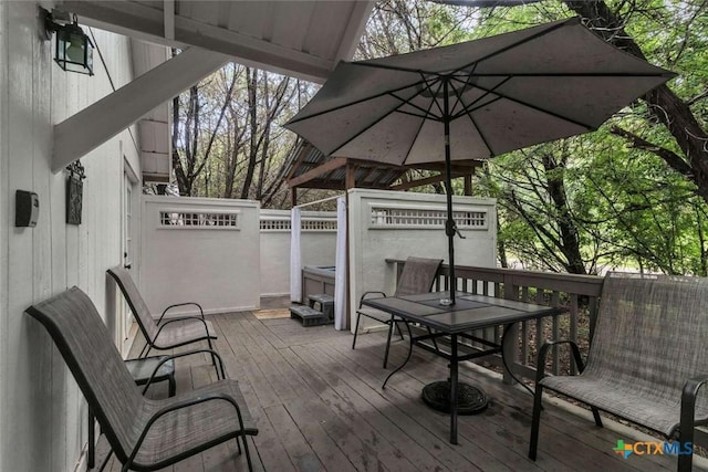 wooden terrace featuring outdoor dining area