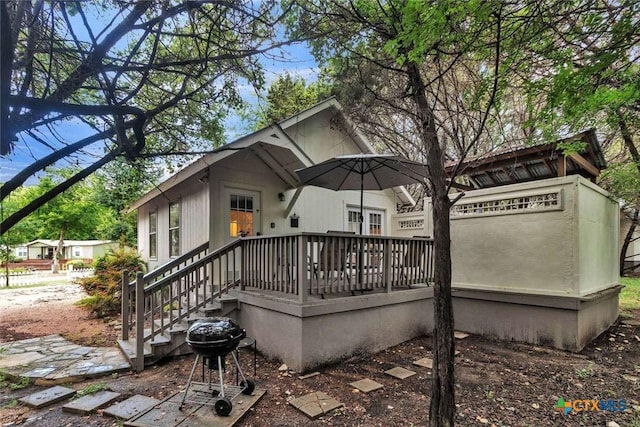 rear view of property with a wooden deck