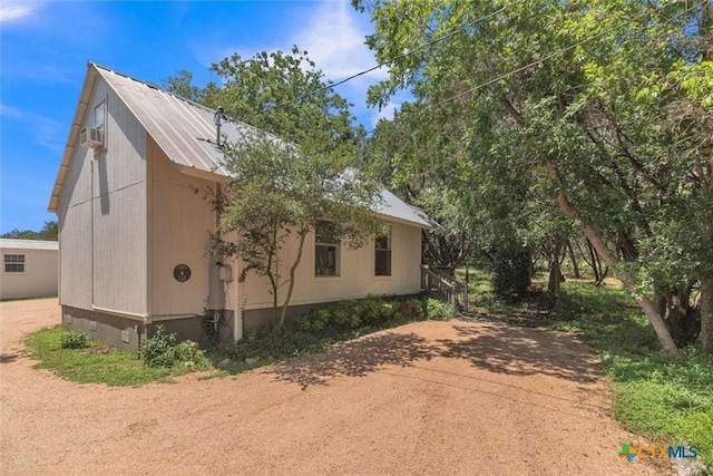 view of side of home with metal roof