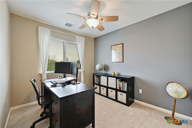 office space with baseboards, visible vents, ceiling fan, and light colored carpet